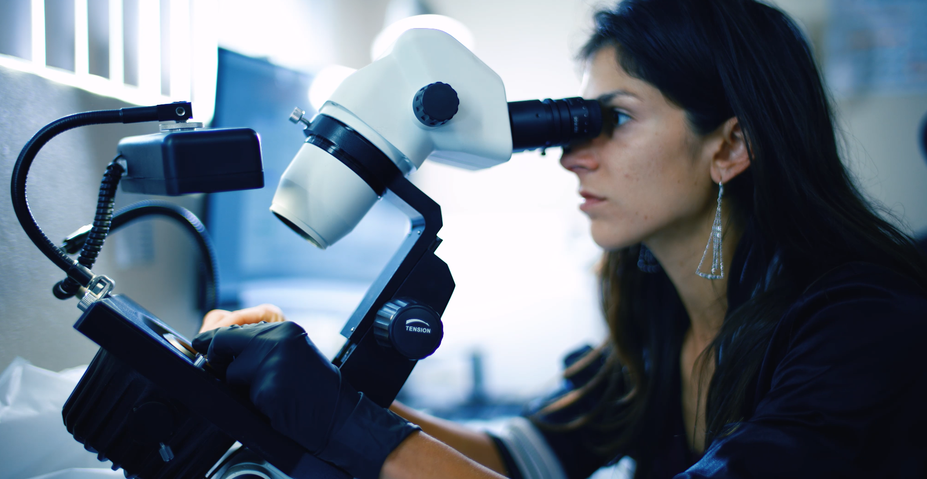 Certified gemologist at microscope